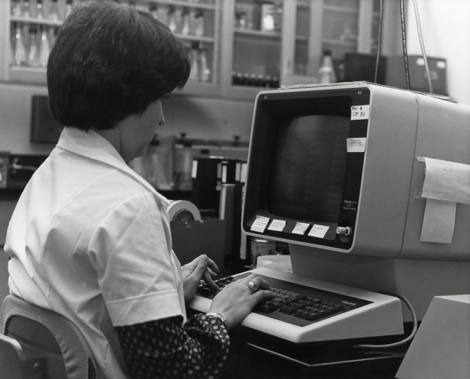A woman typing at a computer terminal, archive photo