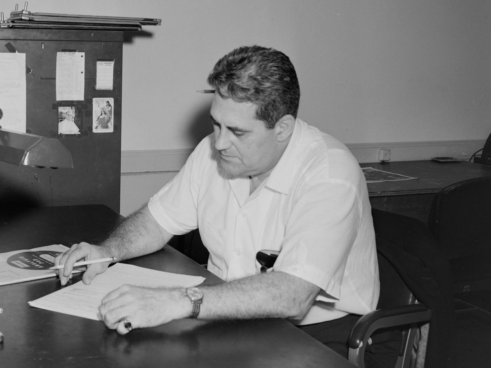 A man reviewing papers at his desk, archive photo